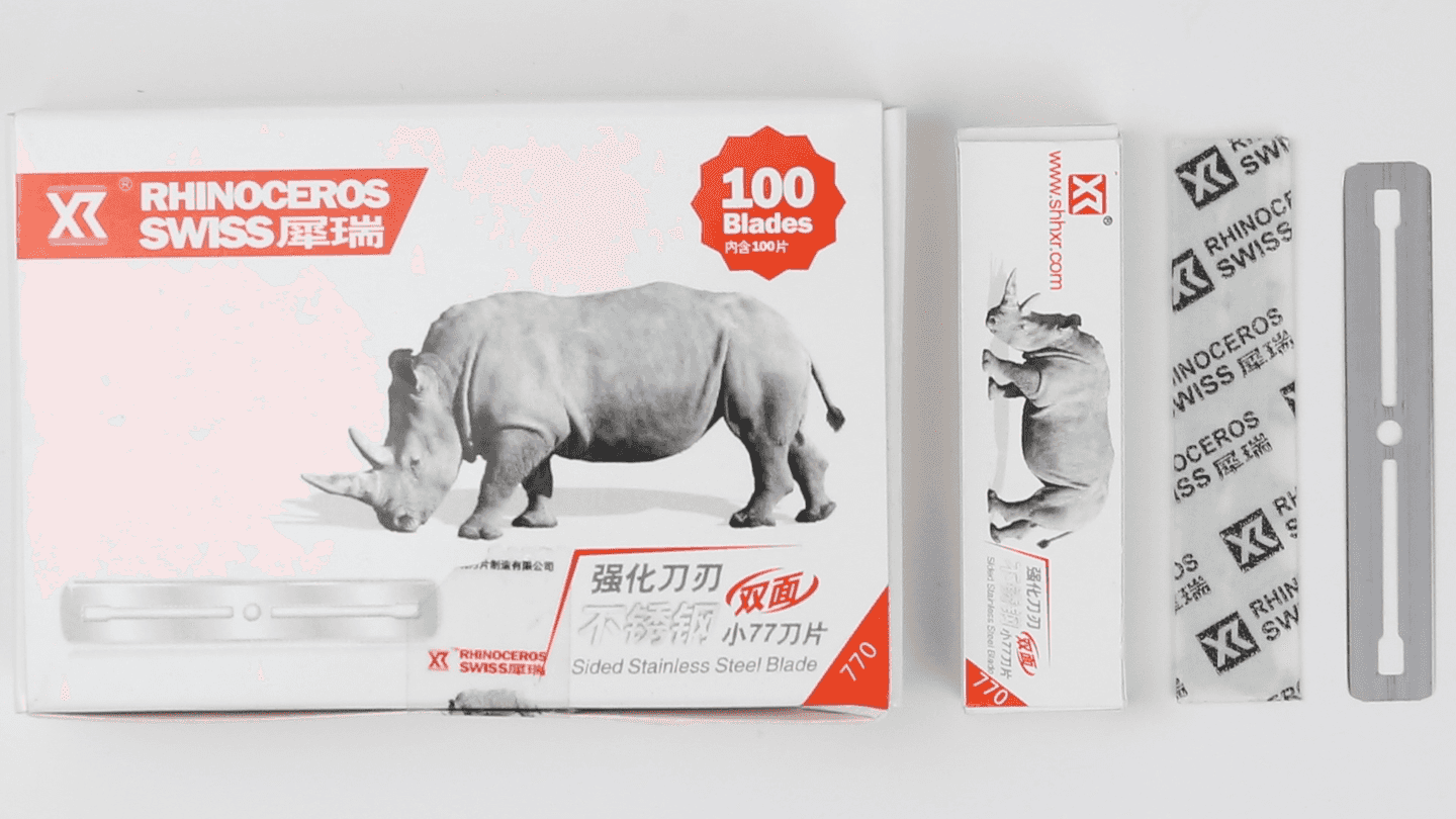 small straight razor blade in white box